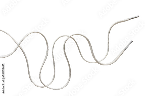 two long unbound wriggling white shoe laces isolated on white photo