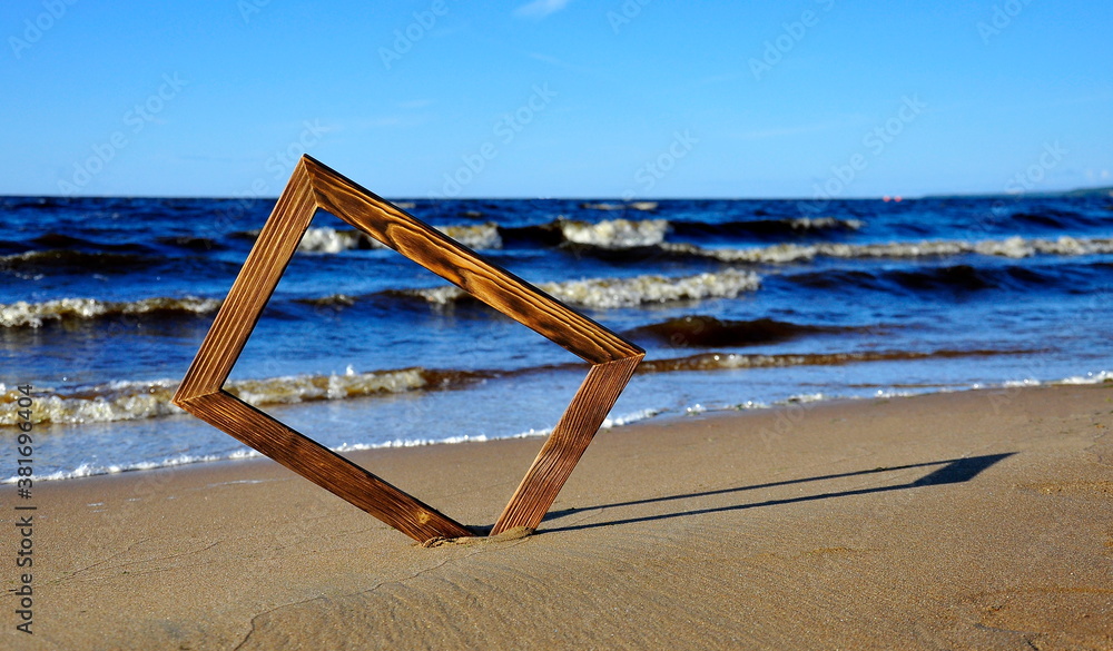 Photo frame on the sea sand by the water. Sea surf background. Photo frame on the sea sand by the water. Sea surf background.