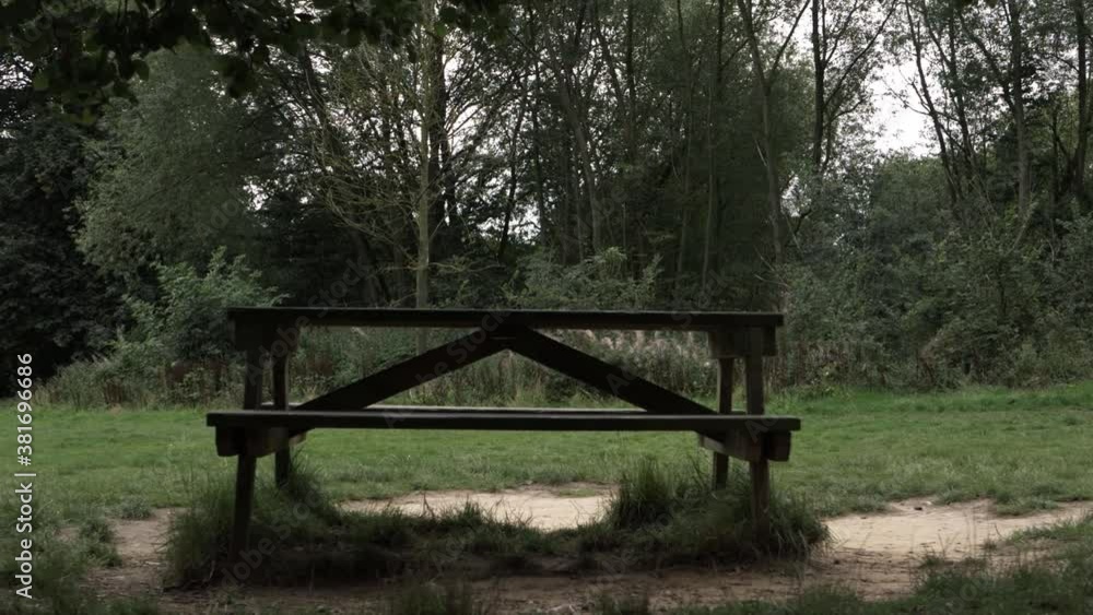 Picnic bench in countryside park wide panning shot Picnic bench in countryside park wide panning shot