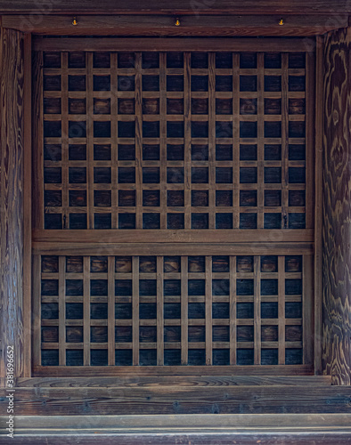 old wooden window with shutters on the wall