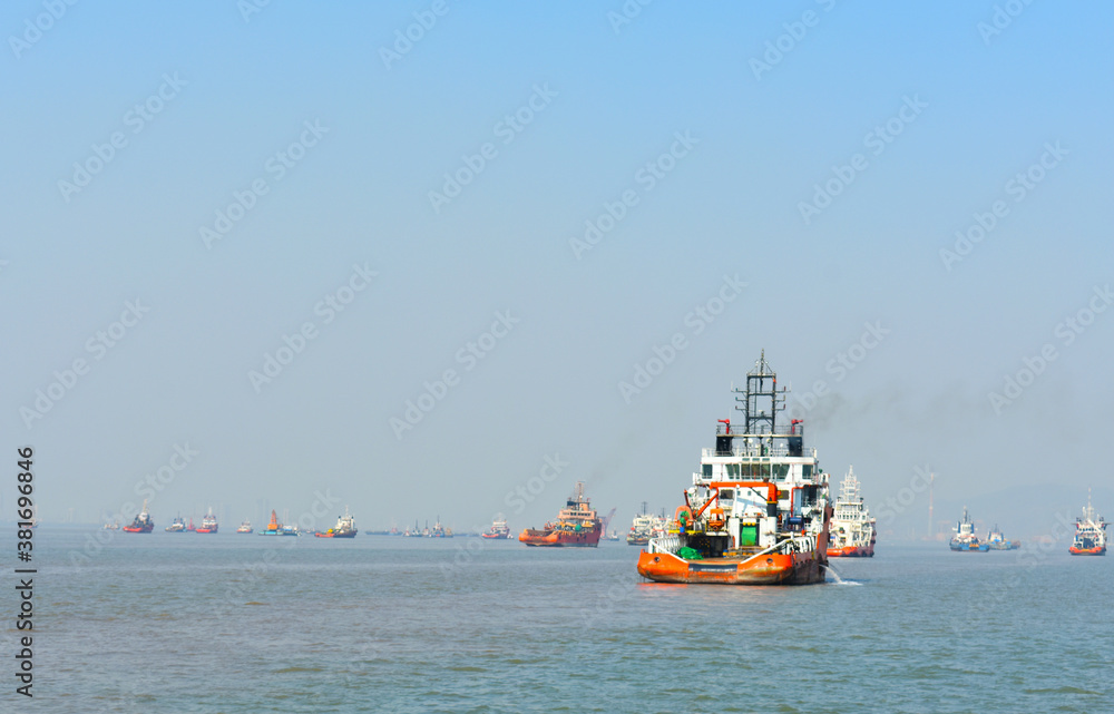 A orange rescue boat floating in the vast blue water in India A orange rescue boat floating in the vast blue water in India