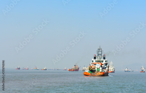 A orange rescue boat floating in the vast blue water in India