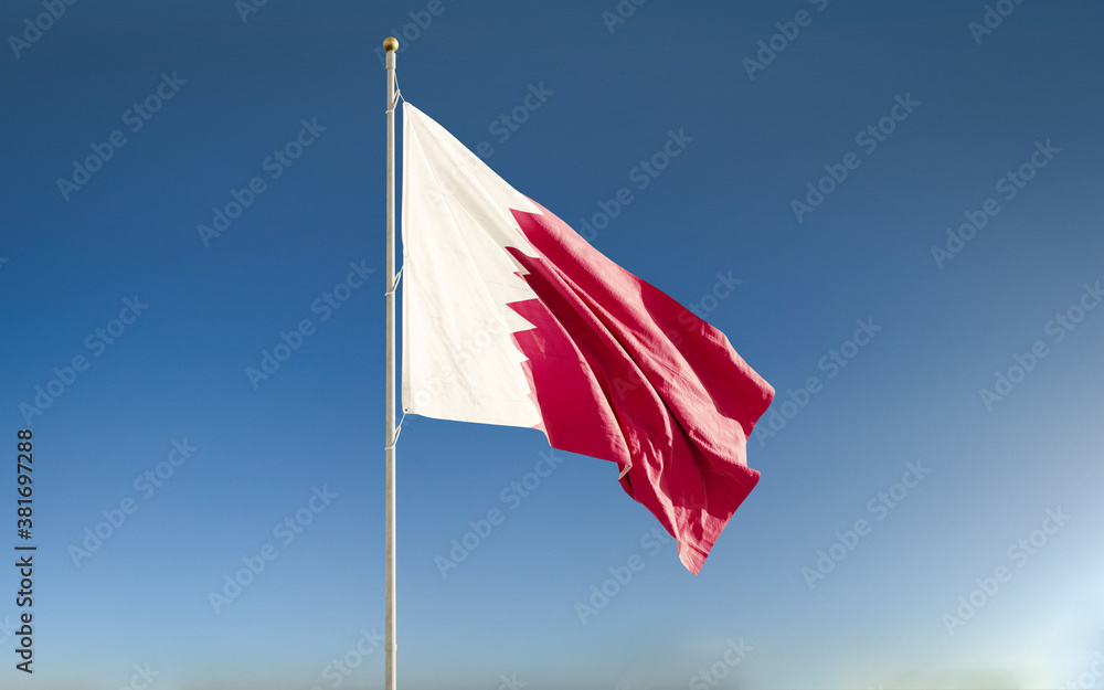 Quatar national flag waving against blue sky background. Isolated. Quatar national flag waving against blue sky background. Isolated.