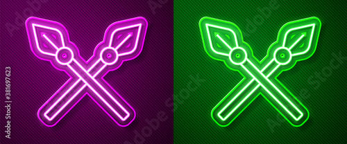 Glowing neon line Crossed medieval spears icon isolated on purple and green background. Medieval weapon. Vector.
