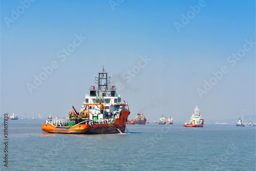 Beautiful orange boat standing in the middle of the ocean with blue sky