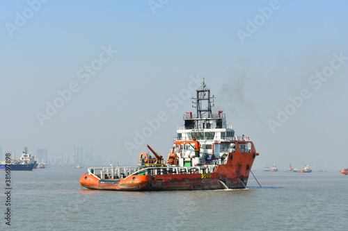 A service boat standing in the middle of the ocean under blue sky © SUBHAJIT