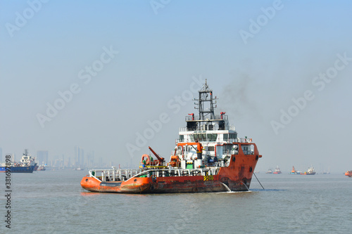 A service boat standing in the middle of the ocean under blue sky