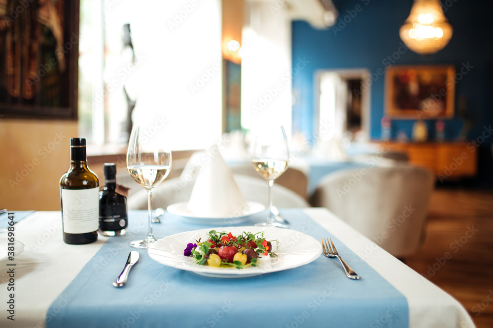 Restaurant table served with spanish tomato salad