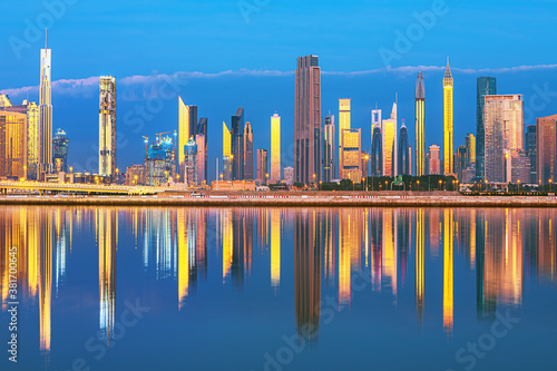 Dubai skyline with reflection in the river at sunrise , Dubai, United Arab Emirates 