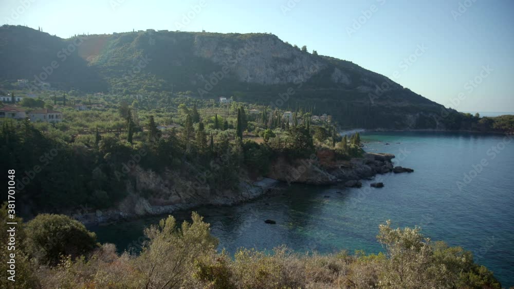 Wide angle scenic view of Neo Proastio in Greece. Residential and holiday properties surrounded by trees and sea Wide angle scenic view of Neo Proastio in Greece. Residential and holiday properties surrounded by trees and sea