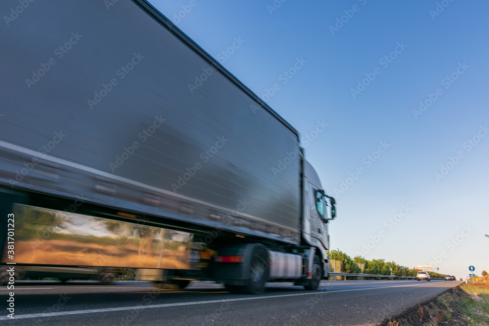 Truck with semi-trailer driving fast on the highway