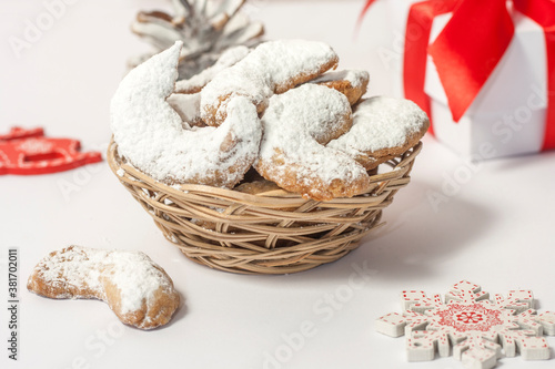 Traditional Austrian and German crescent-shaped Christmas pastries - Vanillekipferl - on a white table with Christmas decorations