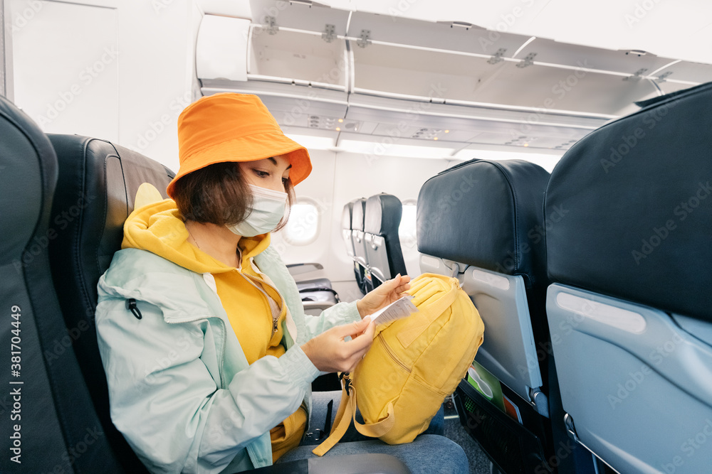 Passenger in protective medical masks are waiting for the plane to take off. Corona virus pandemic concept. Passenger in protective medical masks are waiting for the plane to take off. Corona virus pandemic concept.