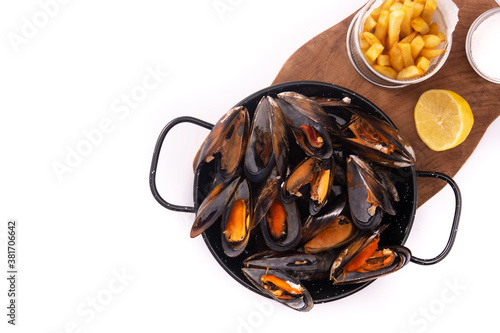 Moussels and french fries or molues-frites isolated on white background. Top view. Copy space photo