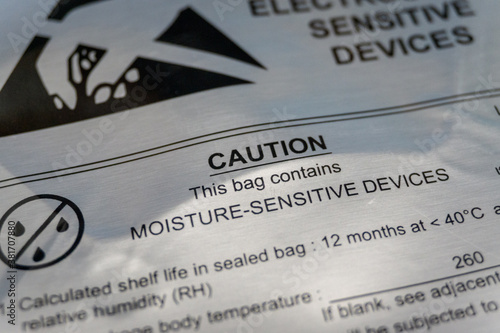 Close-up of moisture barrier bag caution warning label from electronics manufacturing industry