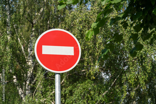 road sign brick against trees as a symbol of new restrictions due to coronavirus