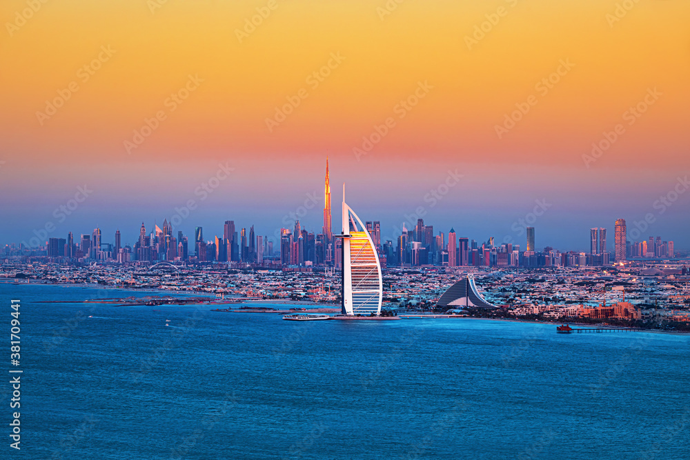 Dubai city - amazing city center skyline and famous Jumeirah beach at sunset, United Arab Emirates