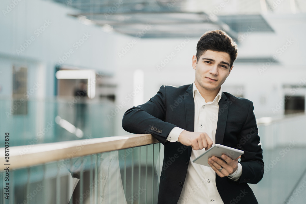 confident young business man businessman and manager looking at the camera. black stylish business suit