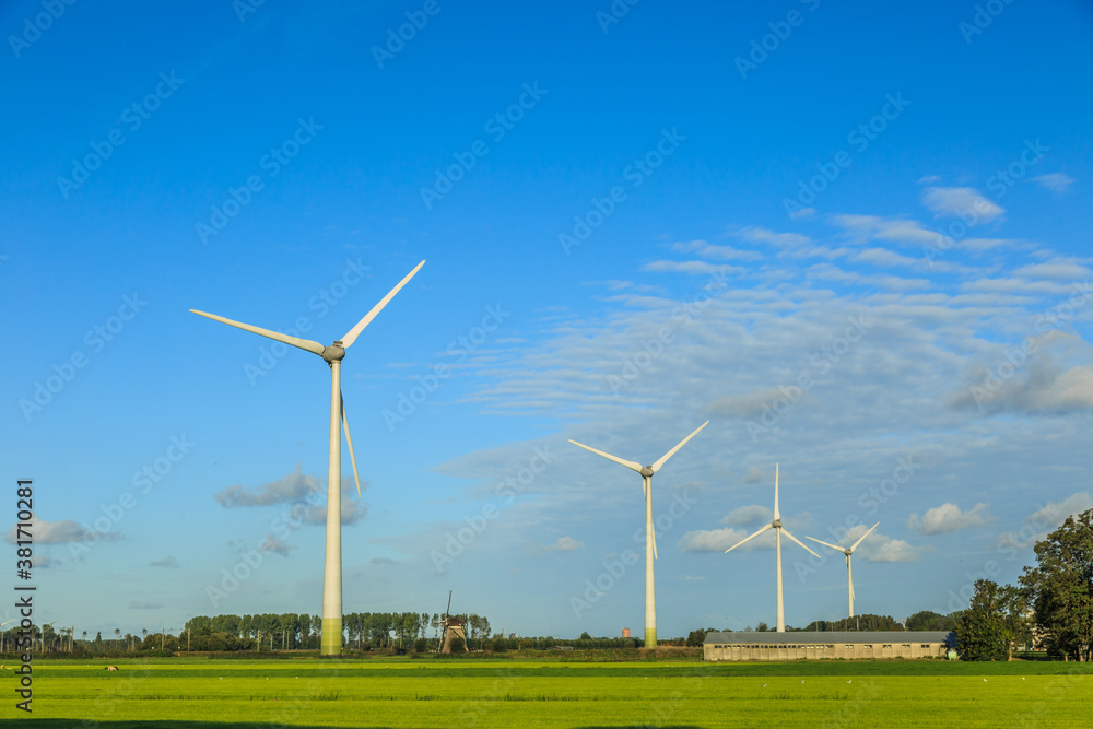Dutch polder landscape with modern windturbines for the sustainable production of electricity for the climate-neutral production of Heineken Beer for the Dutch and European markets Dutch polder landscape with modern windturbines for the sustainable production of electricity for the climate-neutral production of Heineken Beer for the Dutch and European markets