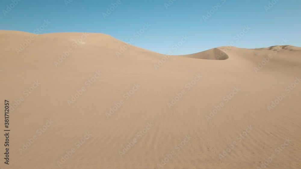 Aerial View Of People Standing Atop Large Desert Dune In Huacachina, Peru Aerial View Of People Standing Atop Large Desert Dune In Huacachina, Peru
