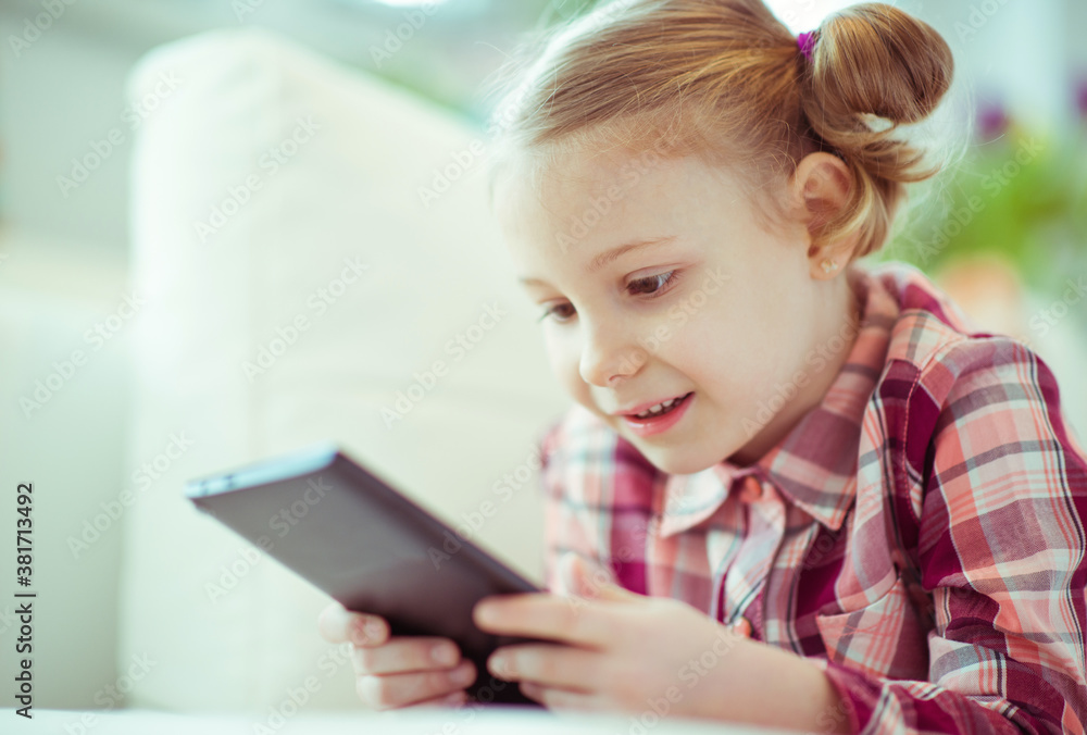 Portrait of cute little child girl with tablet at digital homeschooling Portrait of cute little child girl with tablet at digital homeschooling
