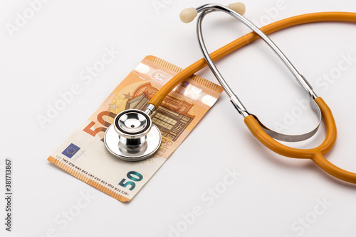 stethoscope on a 50 euro banknote, cost of healthcare, ecomony health