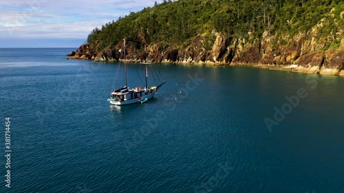 Drone shot of sailboat in bay at Hook Island with people on deck. Near Whitsunday Island Australia photo