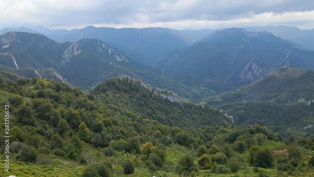 Aerial view of tranquil green mountain valley under an overcast sky, Asturias, Spain Aerial view of tranquil green mountain valley under an overcast sky, Asturias, Spain