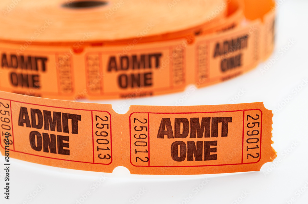 Carnival draw winner, admit one ticket and movie theater admission concept with close up on orange color roll of raffle tickets