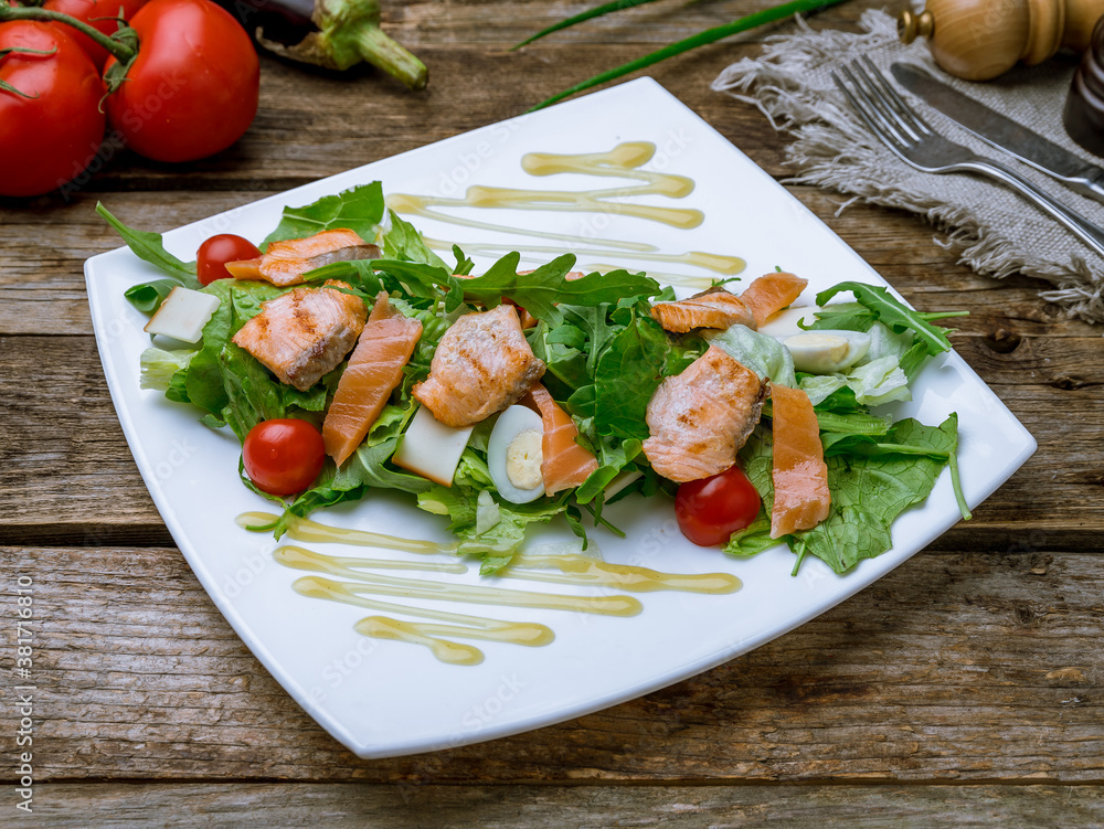 mixed salad with salmon on old wooden table mixed salad with salmon on old wooden table