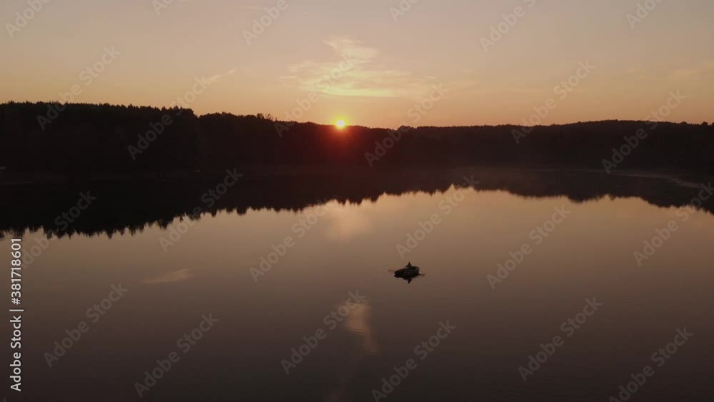 Boat Cruising The Beautiful Calm Lake At Sunset In Rogowko, Poland - Wide Shot Panning Boat Cruising The Beautiful Calm Lake At Sunset In Rogowko, Poland - Wide Shot Panning
