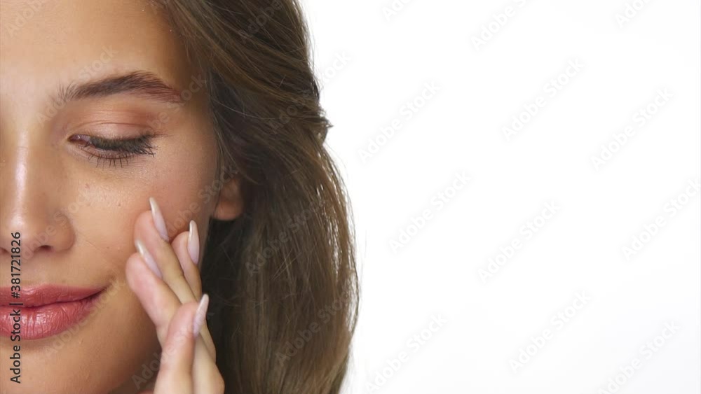 close-up of charming girl applying product on her face close-up of charming girl applying product on her face