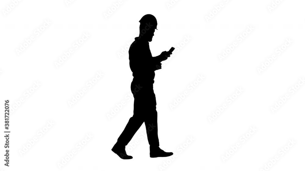 Engineer walking and using smartphone, Alpha Channel Engineer walking and using smartphone, Alpha Channel