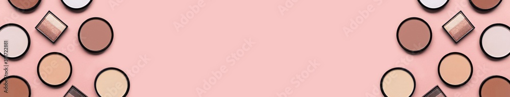 Beige blush, eyeshadow and mineral compact face powder on a pastel pink background. Banner. Place for text. Copy space. Top view. Trendy colors. Makeup. Cosmetic products. Tonal foundation. Flat lay.