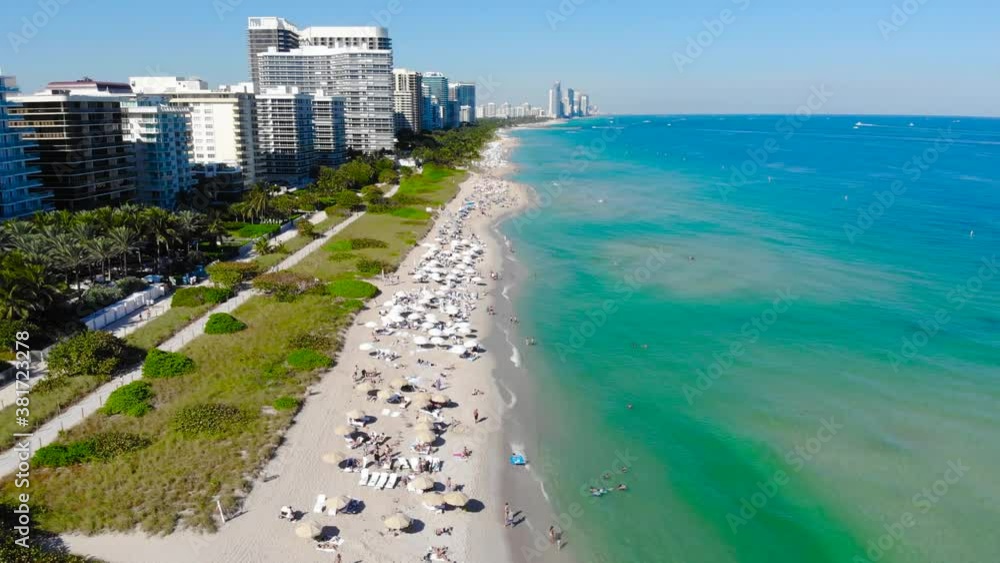 Very busy tourist beach packed as seen from above in Surfside Florida Very busy tourist beach packed as seen from above in Surfside Florida