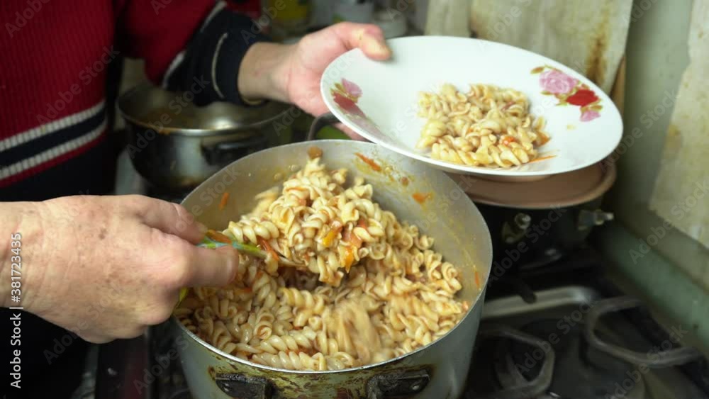 Clouse up cooking and serving homemade red noddles, typical peruvian food Clouse up cooking and serving homemade red noddles, typical peruvian food