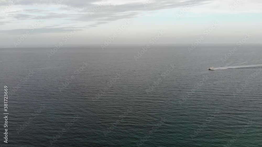Luxury boat cruises over vast open ocean at speed Luxury boat cruises over vast open ocean at speed