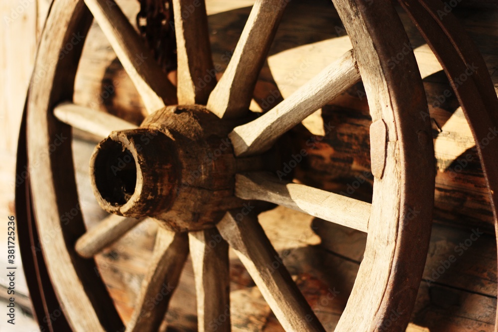 Wooden brown cart wheel close up view Wooden brown cart wheel close up view