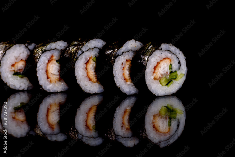 Fresh delicious beautiful sushi rolls on a dark background Fresh delicious beautiful sushi rolls on a dark background