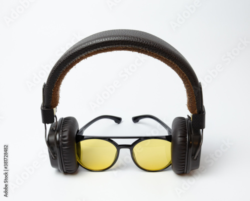 on-ear headphones and sunglasses on a white background