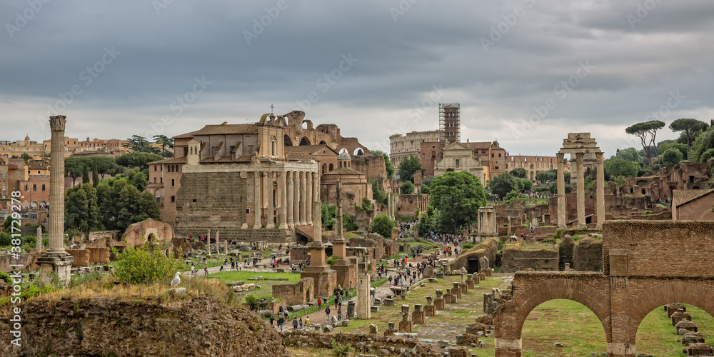 Panoramic view of the ruins the Roman Forum. Tourists visit the Roman Forum ancient ruins in the historic center of Rome, Italy