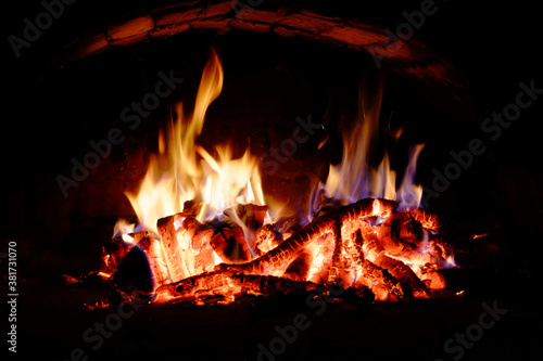 Logs burning in the oven. Flames and heat on the wood. Hot logs.