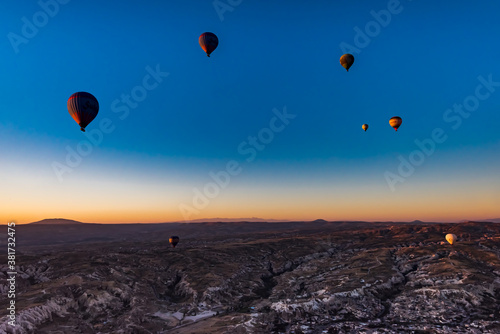 Hot air balloons at sunrise in Goreme National Park, Cappadocia, Turkey.