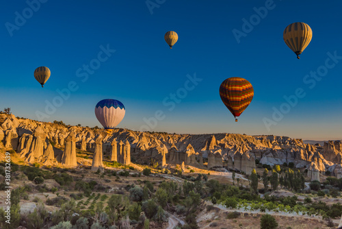 Hot air balloons at sunrise in Goreme National Park, Cappadocia, Turkey.