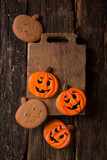 halloween gingerbread cookie in the form of pumpkins on a wooden table. Vertical background