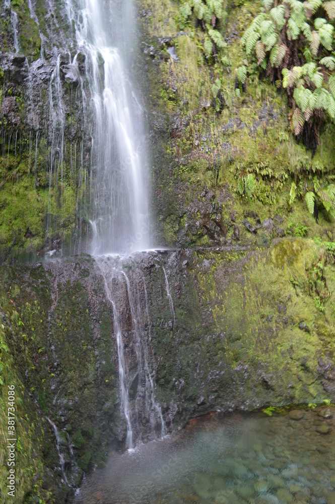 Hiking on the green paths of the levadas and waterfalls on Madeira Island in Portugal Hiking on the green paths of the levadas and waterfalls on Madeira Island in Portugal