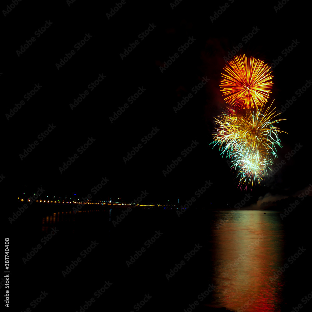 Fireworks over the coastline of the big city. Recreation and entertainment concept. Fireworks over the coastline of the big city. Recreation and entertainment concept.