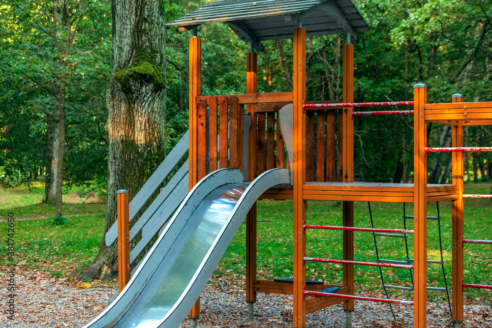 Wooden children playground with slide, ladder, bridge in the forest. Wooden children playground with slide, ladder, bridge in the forest.