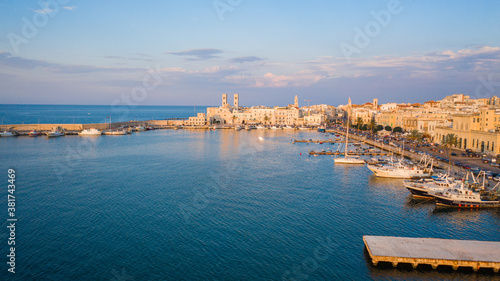 Φωτογραφία Beautiful panoramic aerial view photo from flying drone on Molfetta waterfront with the Old Cathedral San Corrado (Duomo Vecchio),port with ships and yachtsand the Molfetta city sunset