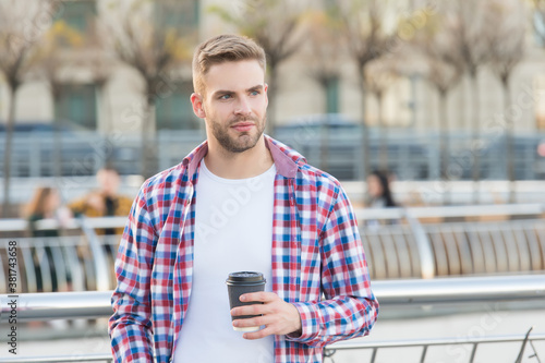casual dressed male drinking morning coffee from cup. unshaven guy with bristle in urban style. modern life concept. student drink tea. handsome young man wear checkered shirt. Breakfast time